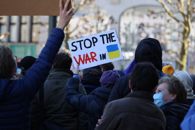 Rear view of people protesting on street