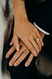 Midsection of couple holding hands