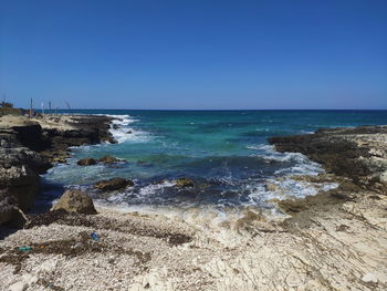 Scenic view of sea against clear blue sky