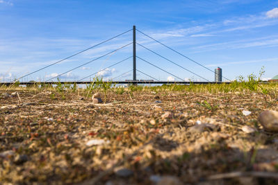 Surface level of railroad track on field against sky