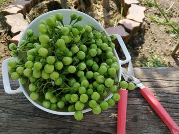 High angle view of grapes in container on table