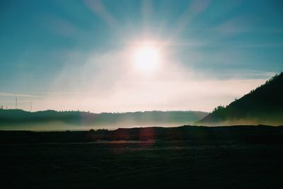 Scenic view of mountains against sky on sunny day