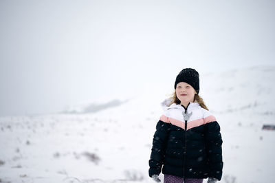 Man standing on snow covered land
