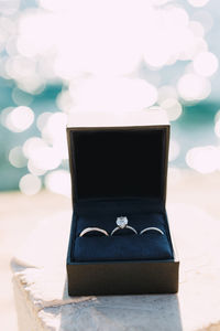 Close-up of wedding rings on table