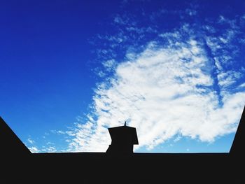 Low angle view of silhouette building against sky