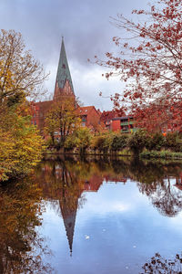 Reflection of trees in lake against sky during autumn