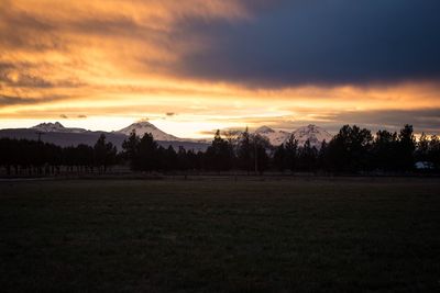 Scenic view of field against sky during sunset