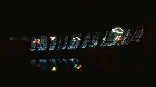 Reflection of illuminated lights in puddle