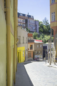 Street amidst buildings against clear sky