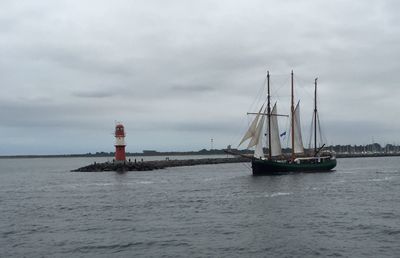 Ship sailing in sea against sky