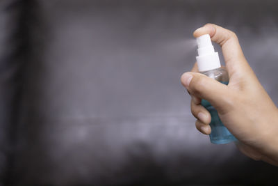 Close-up of person hand holding cigarette