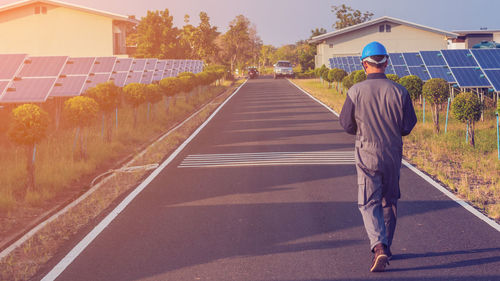 Male engineer walking on road in city