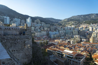 High angle view of city buildings against clear sky