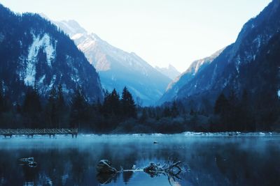 Scenic view of lake and mountains against sky during winter