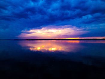 Scenic view of sea against dramatic sky during sunset