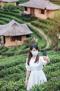 Young woman using smart phone outdoors