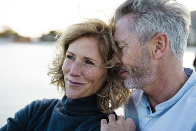 Smiling mature man embracing woman at vacation