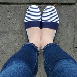Low section of woman standing on tiled floor