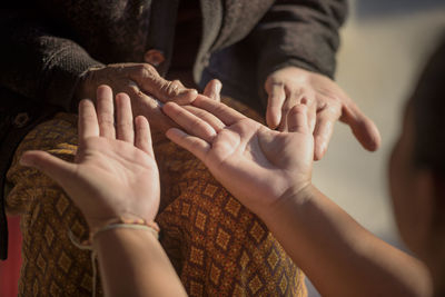 Close-up of people on hands