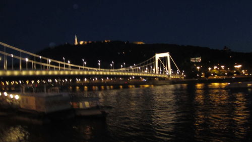 Low angle view of suspension bridge at night