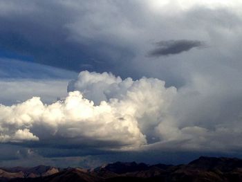 Scenic view of mountains against cloudy sky