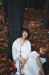 Young woman in autumn leaves