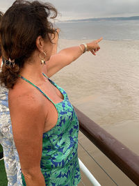 Midsection of woman standing at beach