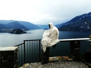 Scenic view of lake by mountains against sky