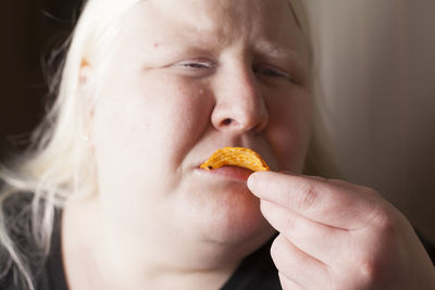 Close-up of woman eating potato chip