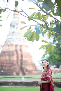 Portrait of woman in traditional clothing standing outdoors