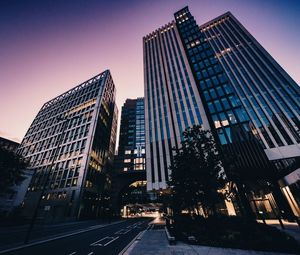 Low angle view of buildings against sky at dusk