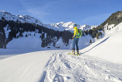 Full length of person skiing on snowcapped mountain