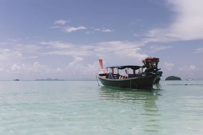Boat sailing in sea against sky