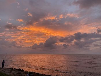 Scenic view of sea against sky at sunset