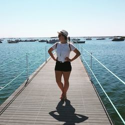 Full length of woman standing on sea shore against sky