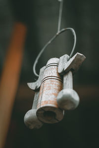 Close-up of rusty metal hanging against wall