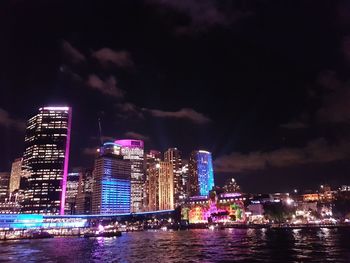 Illuminated city at waterfront