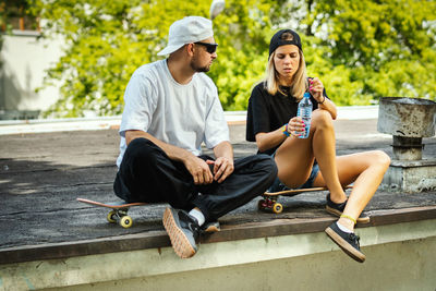 Couple sitting at skateboard park