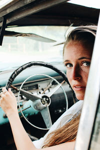 Close-up portrait of woman sitting in car