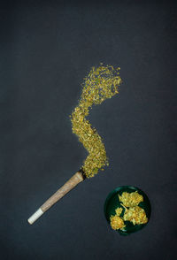 Directly above shot of yellow flower against black background