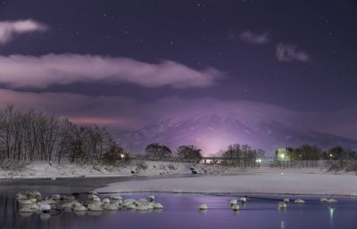 Scenic view of snow covered landscape at dusk