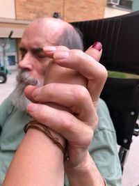 Midsection of man holding hands