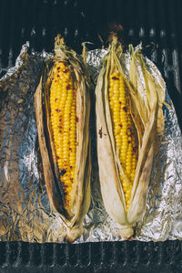 High angle view of corns on foil paper