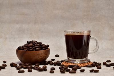 Coffee beans and coffee drink on a gray background