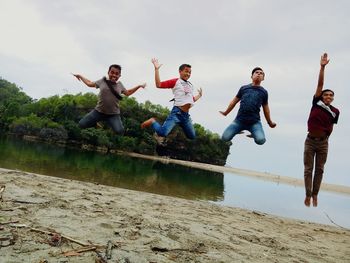 Friends jumping in water