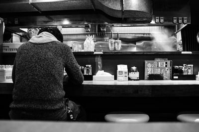 Rear view of man working in restaurant