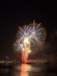 Low angle view of firework display against sky at night