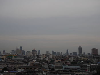 High angle view of buildings in city against sky