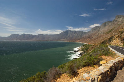 Scenic view of sea and mountains against sky