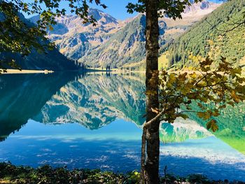 Scenic view of lake and mountains against sky